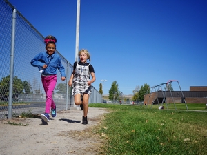 Fourth graders Kylah Thunder and Shayla McNair run a recess lap at Baldwin Creek Elementary School in Lander on Sept. 26, 2023. (Katie Klingsporn/WyoFile)