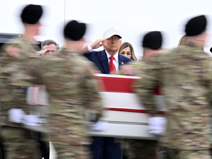 President Donald Trump salutes as a U.S. Army carry team moves a flag-draped transfer case containing the remains of Sgt. Declan J. Coady at Dover Air Force Base on March 07, 2026 in Dover, Delaware. Six soldiers from the 103rd Sustainment Command were killed in action by an Iranian drone strike on March 1 in Port Shuaiba, Kuwait during "Operation Epic Fury". (Photo by Roberto Schmidt/Getty Images)