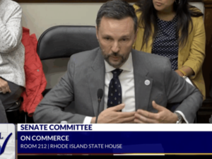 Greg Cornett, president of Rhode Island Energy, testifies in support of a bill to let energy distribution companies own generation facilities during a Senate Committee on Commerce hearing on April 28. (Screenshot by Capitol TV)