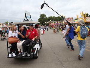 The late Sen. Lindsey Graham, R-S.C., right, at the time a candidate for president, rides on the back of a golf cart with his sister Darlin