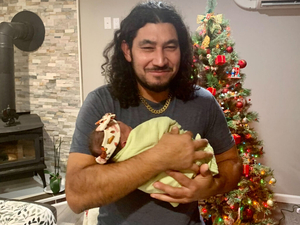 Rudy Villeda Mejía, pictured holding his granddaughter, fears deportation back to his native Honduras due to violence he faced in the country. He has lived in the U.S. since 2010. (Photo courtesy of Mabel Shaffer)
