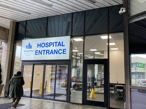 A person walks into University Hospital in Newark, New Jersey. The state has had one of the largest drops in death rates since 2015, according to a Stateline analysis. (Photo by Terrence McDonald/New Jersey Monitor)