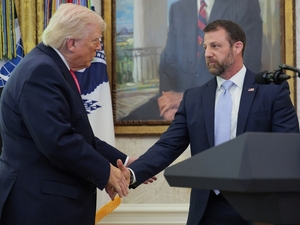 President Donald Trump shakes hands with newly sworn in Homeland Security Secretary Markwayne Mullin during a ceremony in the Oval Office on March 24, 2026. (Photo by Chip Somodevilla/Getty Images)