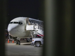 An airplane sits on the tarmac at Mesa Gateway Airport on the evening of April 9, 2026, outside of the Arizona Removal Operations Coordination Center, an ICE facility where detainees are temporarily housed before they are put on a plane to either be deported or moved to a different ICE facility. (Photo by Jerod MacDonald-Evoy/Arizona Mirror)