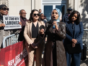 Democratic U.S. Rep. Ilhan Omar of Minnesota speaks during a rally in support of Rep. LaMonica McIver, D-N.J., outside a federal courthouse in Newark, New Jersey, on Oct. 21, 2025. She is flanked by Democratic Reps. Sara Jacobs of California, left, and Jasmine Crockett of Texas, right. (Photo by Reena Rose Sibayan/New Jersey Monitor)
