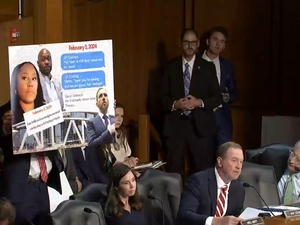 Sen. Eric Schmitt, R-Mo., speaks during a U.S. Senate Judiciary Committee hearing while a poster is displayed purporting to show text messages between former special counsel Jack Smith and security personnel about his attendance at an Atlanta Hawks NBA game. Smith actually had attended a University of Iowa Hawkeyes women's basketball game. (Screenshot from Judiciary Committee webcast)