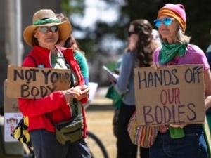 Maryalice Snider and Ann Acuff stand in protest outside the Wyoming Supreme Court before the court hears the appeal of a district court abortion decision on Wednesday, April 16, 2025, in Cheyenne. (Milo Gladstein/Wyoming Tribune Eagle)