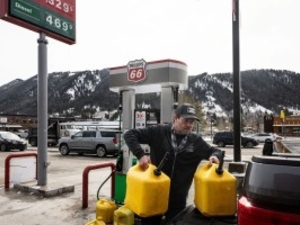 Neil Albert, of Victor, Idaho, lifts gallons of red-dyed diesel fuel into the bed of his truck Wednesday, March 11, 2026, at the Phillips 66 gas station in Jackson. Gas prices around the country have soared following the start of the war in Iran and costs around Jackson are no exception. (Charlie Nick/Jackson Hole Daily)