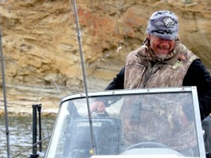 Robb Keith laughs while fishing for puppy lake trout on Flaming Gorge Reservoir, a pursuit that’s a personal passion. The Green River resident supervised the fishery for the Wyoming Game and Fish Department for a quarter century before retiring in 2025. (Mike Koshmrl/WyoFile)