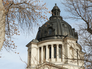 Governor celebrates surplus as Democratic lawmaker says state missed opportunities to help people