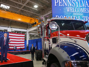 Trump campaigns with Mackenzie at Mack Trucks plant affected by tariff layoffs