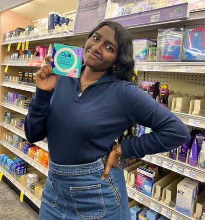 Sriha Srinivasan, 21, holds up a box of Opill on March 22, the first day it became available locally at a local drugstore
