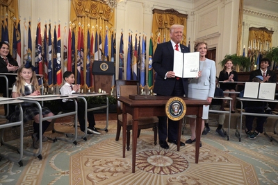 President Donald Trump stands with Secretary of Education Linda McMahon after signing an executive order to reduce the size and scope of the Education Department during a ceremony in the East Room of the White House on March 20, 2025 in Washington, DC. The order instructs McMahon, former head of the Small Business Administration and co-founder of the World Wrestling Entertainment, to shrink the $100 billion department, which cannot be dissolved without Congressional approval. (Photo by Chip Somodevilla/Gett