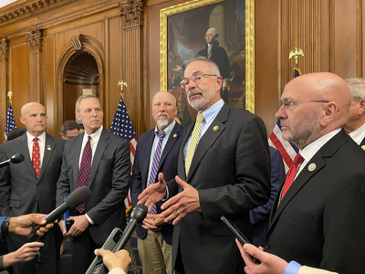 Rep. Chip Roy stands to the left of U.S. House Freedom Caucus Chair Rep. Andy Harris as he speaks with reporters in May.