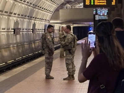 A passenger takes a photo of members of the National Guard in the Union Station Metro station in Washington, D.C., on Aug. 20, 2025. (Photo by Jane Norman/States Newsroom)