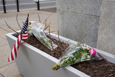 WASHINGTON, DC - NOVEMBER 27: A small memorial of flowers and an American flag has been set up outside the Farragut West Metro station on November 27, 2025 in Washington, DC. Two members of the West Virginia National Guard were shot on November 26 blocks from the White House in what authorities are calling a targeted shooting. (Photo by Andrew Leyden/Getty Images)