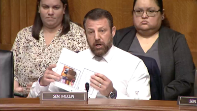 Sen. Markwayne Mullin, an Oklahoma Republican, is shown holding a printout of the social media post that led him to challenge the head of the Teamsters union to a physical fight at a U.S. Senate hearing Tuesday, Nov. 14, 2023. (U.S. House webcast screenshot)