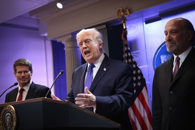President Donald Trump speaks during a press briefing at the White House Feb. 20, 2026 in Washington, D.C., after the U.S. Supreme Court ruled against Trump’s use of emergency powers to implement international trade tariffs. At left is Solicitor General D. John Sauer and at right is Secretary of Commerce Howard Lutnick. (Photo by Kevin Dietsch/Getty Images)