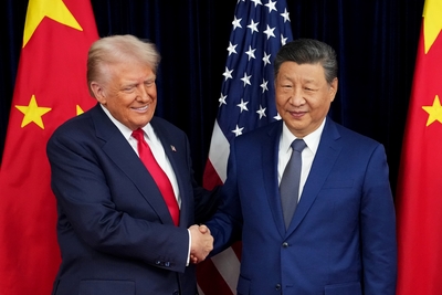 President Donald Trump greets Chinese President Xi Jinping ahead of a bilateral meeting at Gimhae Air Base on October 30, 2025, in Busan, South Korea. Trump arrived in China on Wednesday for another meeting with Xi. (Photo by Andrew Harnik/Getty Images)