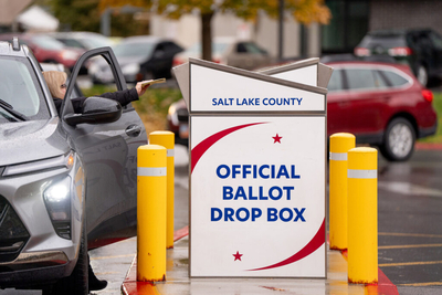 A voter drops off a ballot in a drop box at the Salt Lake County Government Center in Salt Lake City on Election Day, Tuesday, Nov. 5, 2024. (Photo by Spenser Heaps for Utah News Dispatch)