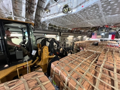 a forklift and hundreds of boxes in a warehouse