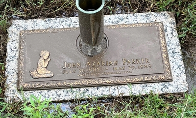A photo of a gravestone in a cemetery with the name John Azariah Parker engraved on it