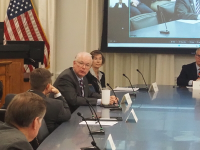 Dave Boliek speaks at a conference table beside other members of the North Carolina Council of State.
