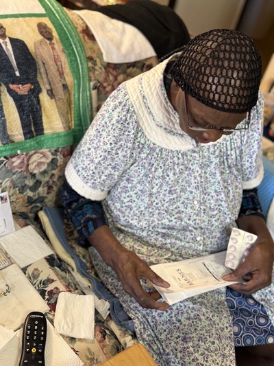 A woman holds her prescription medication.