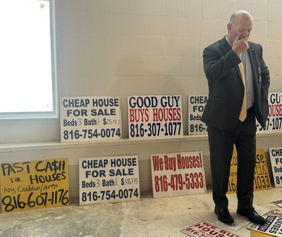 The signs offer quick cash for homes. But states want more oversight.