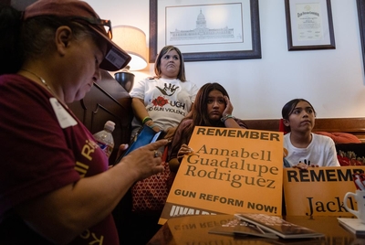 Family members of the Robb Elementary shooting victims and their supporters wait to meet with an aide of a state senator to ask the lawmaker to consider supporting gun reform legislation.