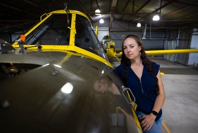 Cricia Ryan poses on one of her family’s Air tractor crop-dusters in El Campo, TX, on Monday, April 3, 2023.