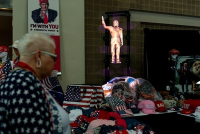 A woman browses through Trump merchandise at the Texas GOP Convention at the Henry B. Gonzalez Convention Center last year.