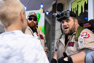 Zach Grannan, a member of the North Texas Ghostbusters, speaks with kids and shows them his gear on Friday, Oct. 18, 2024 in Denton, Texas. The North Texas Ghostbusters have set up their headquarters in the Discover Denton shop, bringing all their Ghostbusters gear and items to show off to the town.