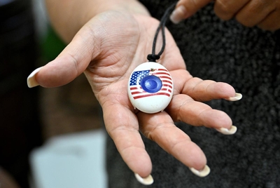 The Director of Operations Brenda Hobson shows an art pendant that residents use to inform nurses that they require assistance on Friday, July 12, 2024, at Ella Springs Senior Living Community in Houston, Tx. During the blackouts these pendants ceased functioning, and staff had to continuously make rounds to check residents’ apartments in order to assure there was no one in distress.