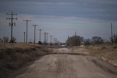 A truck passes a county road in Bailey Co. on March. 6, 2023.
