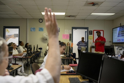 Calvin Green, a reentry specialist who used to be incarcerated, addresses a classroom of women who are incarcerated and enrolled in a Lee College course that focuses on reentry at Lucile Plane State Jail in Dayton, Texas, US, on Monday October 28, 2024.