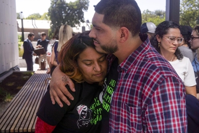 Samantha Casiano is comforted by her husband, Luis Fernando Villasana, following the first day of testimony for Zurawski v. State of Texas outside the Travis County Civil and Family Courts Facility in Austin on July 19, 2023.