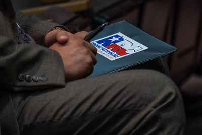 A Texas Railroad Commission sticker adorns a spectator’s binder during at an RRC hearing in the William B. Travis Building in Austin on Nov. 30, 2021.