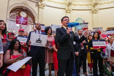 Flanked by House Democrats, state Rep. James Talarico, D-Austin, speaks to public school advocates in the Capitol Rotunda prior to the morning session on April 16, 2025.