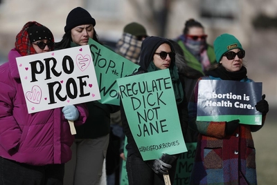 Rally attendees listen while holding signs during the rally. The Amarillo Women’s March hosted a healthcare rally Saturday in front of the Potter County Courthouse in Amarillo