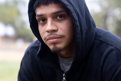 EAGLE PASS, TEXAS - November 8, 2024: Fernando Padron, 26, poses for a portrait at a park in Eagle Pass after he was released on a PR bond from jail. Ilana Panich-Linsman for The New York Times