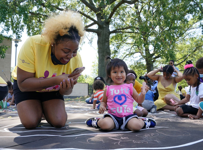 Children from the KU Kids Deanwood Child Care Center complete a mural celebrating the launch of a local child tax credit in 2021 in Washington, D.C. New research suggests cities could significantly reduce childhood poverty by creating their own child tax credit programs. (Photo by Jemal Countess/Getty Images for Community Change)