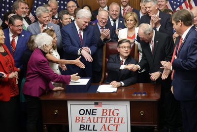 U.S. Speaker of the House Rep. Mike Johnson (R-LA) celebrates with fellow House Republicans during an enrollment ceremony of H.R. 1, the One, Big, Beautiful Bill Act at the U.S. Capitol on July 3, 2025 in Washington, DC. The House passed the sweeping tax and spending bill after winning over fiscal hawks and moderate Republicans. The bill makes permanent President Donald Trump’s 2017 tax cuts, increase spending on defense and immigration enforcement and temporarily cut taxes on tips, while at the same time