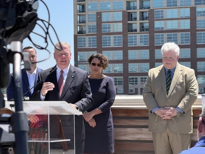 Little Rock Regional Chamber President Jay Chessir promotes an informational website about two data center projects alongside Little Rock Water Reclamation Authority CEO Jean Block (center right) and Central Arkansas Water CEO Tad Bohannan (right).