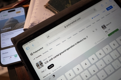 Predictions market sites are shown on electronic devices on Feb. 25, 2026. Online prediction market platforms, such as Polymarket and Kalshi, allow people to place bets on wide-ranging subjects such as sports, finance, politics and currents events. (Photo illustration by Scott Olson/Getty Images)