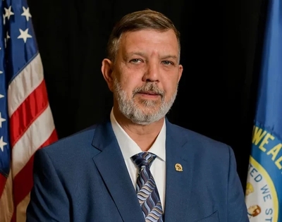 DePriest wears a tie while he speaks.