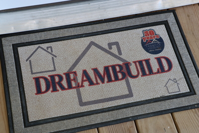 A doormat featuring the DreamBuild logo.