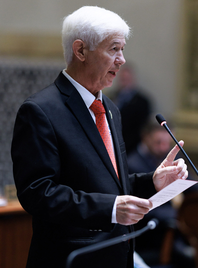 Gary Boswell stands in front of a microphone.