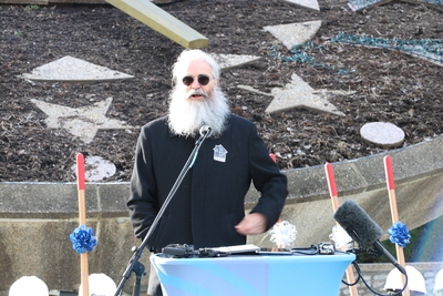 McReynolds stands in front of a podium.