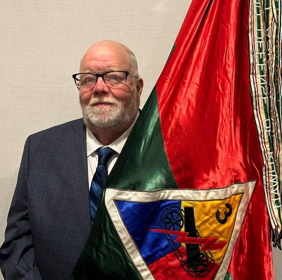 Smeathers poses with a multi-colored flag.